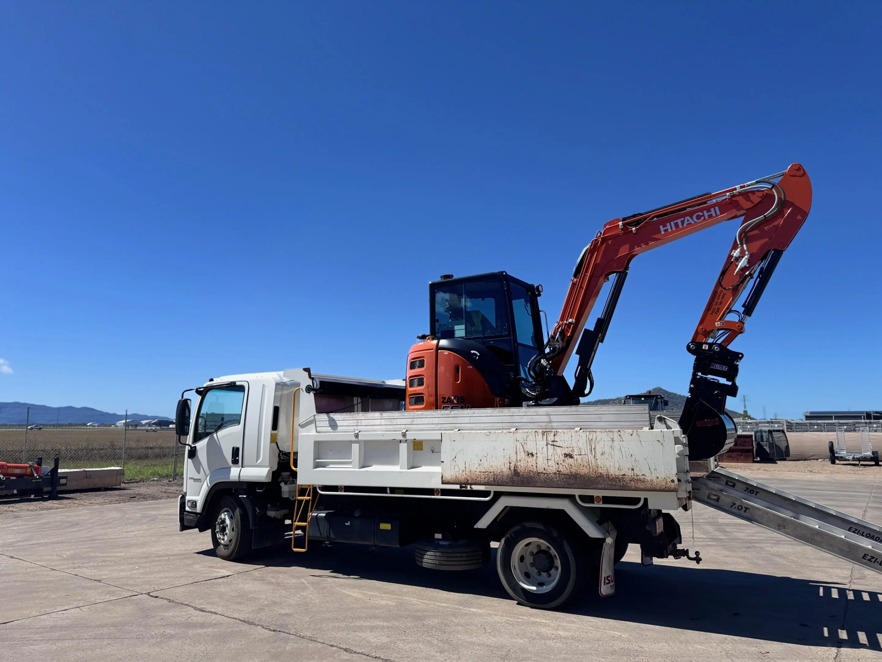 excavator on back of truck