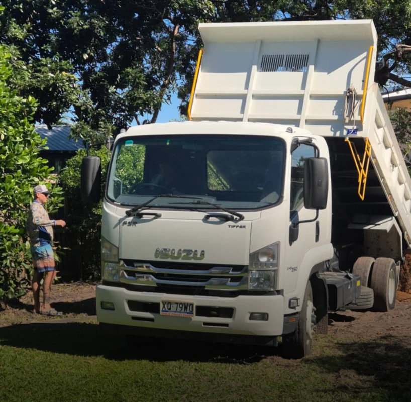 Man supervising dump truck operation